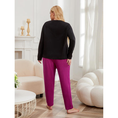 Woman wearing a black top and pink pants in a living room setting