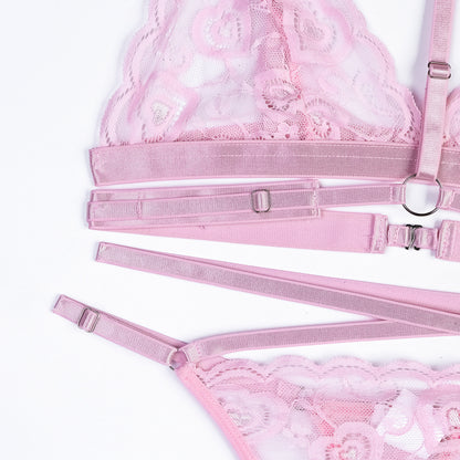 Pink lace lingerie set with garter belt on a white background