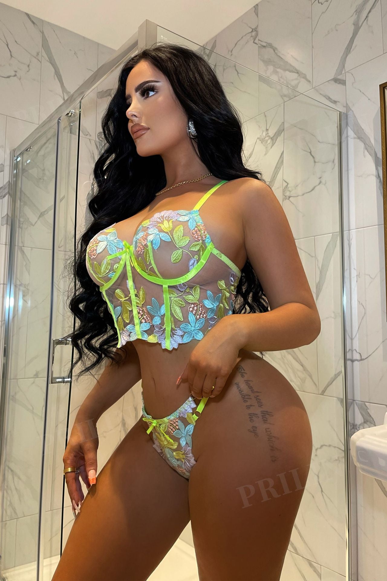 Woman wearing a colorful bikini in a bathroom setting