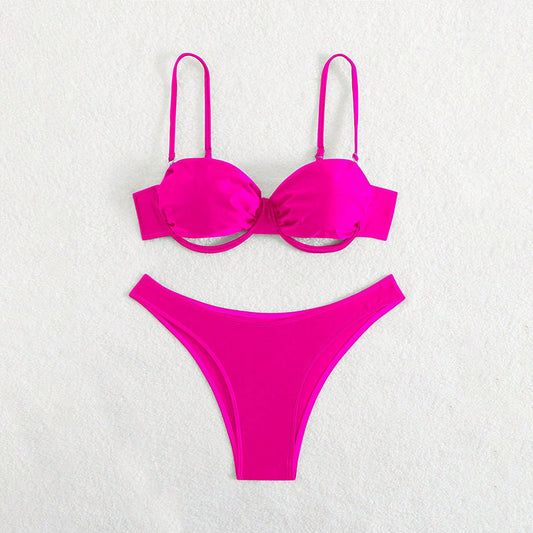 Pink bikini set on a light gray background