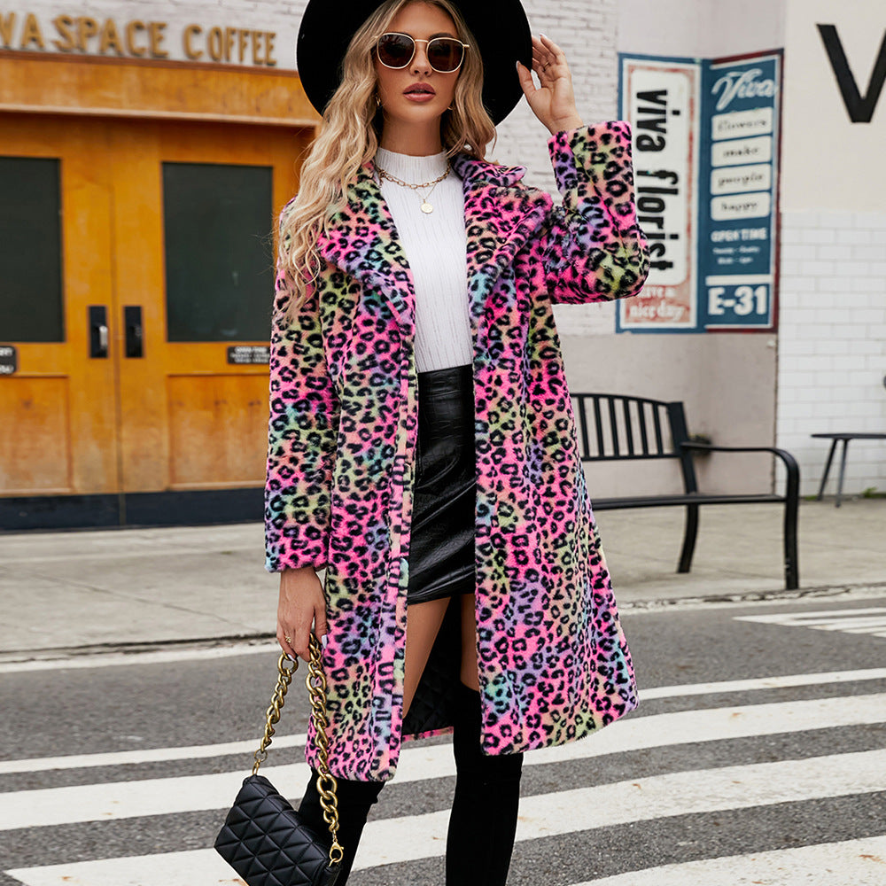 Woman wearing a colorful leopard print coat on a city street.