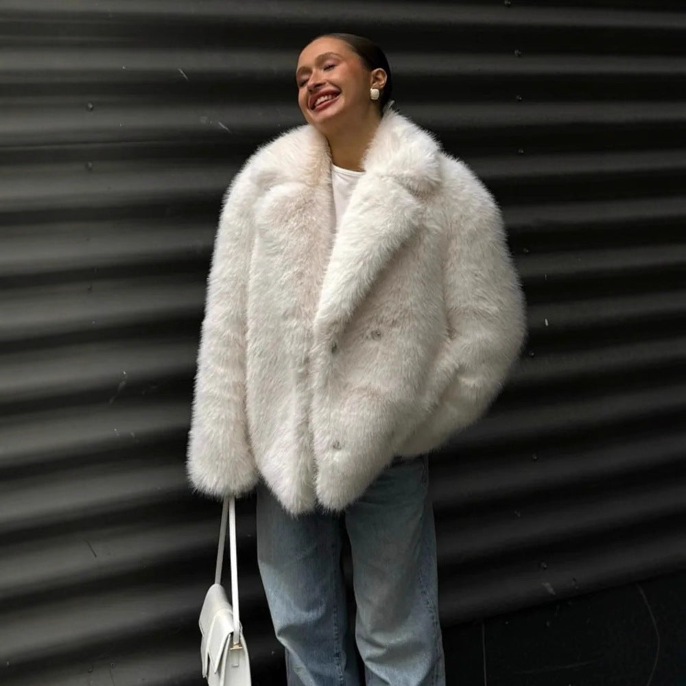 Person wearing a fluffy white coat against a corrugated metal background