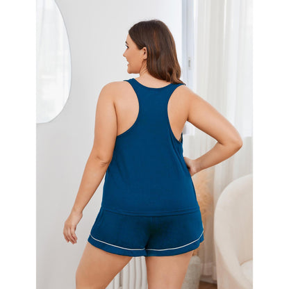 Woman wearing a blue tank top and shorts set in a neutral setting