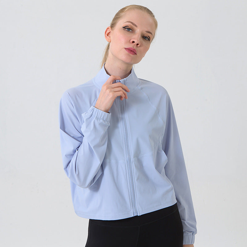 Woman wearing a light blue jacket against a plain background