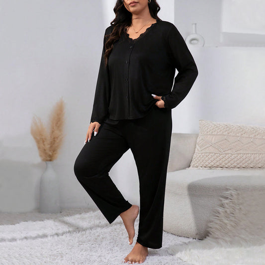Woman wearing a black pajama set in a cozy living room.