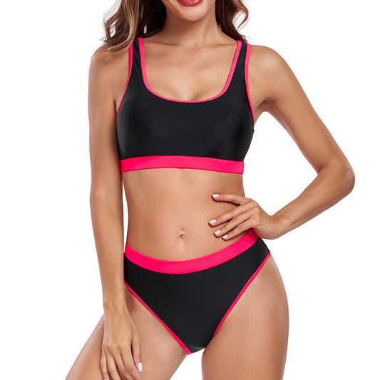 Black and pink bikini set on a model against a white background