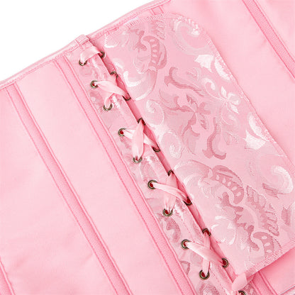 Pink notebook with lace detailing on a white background