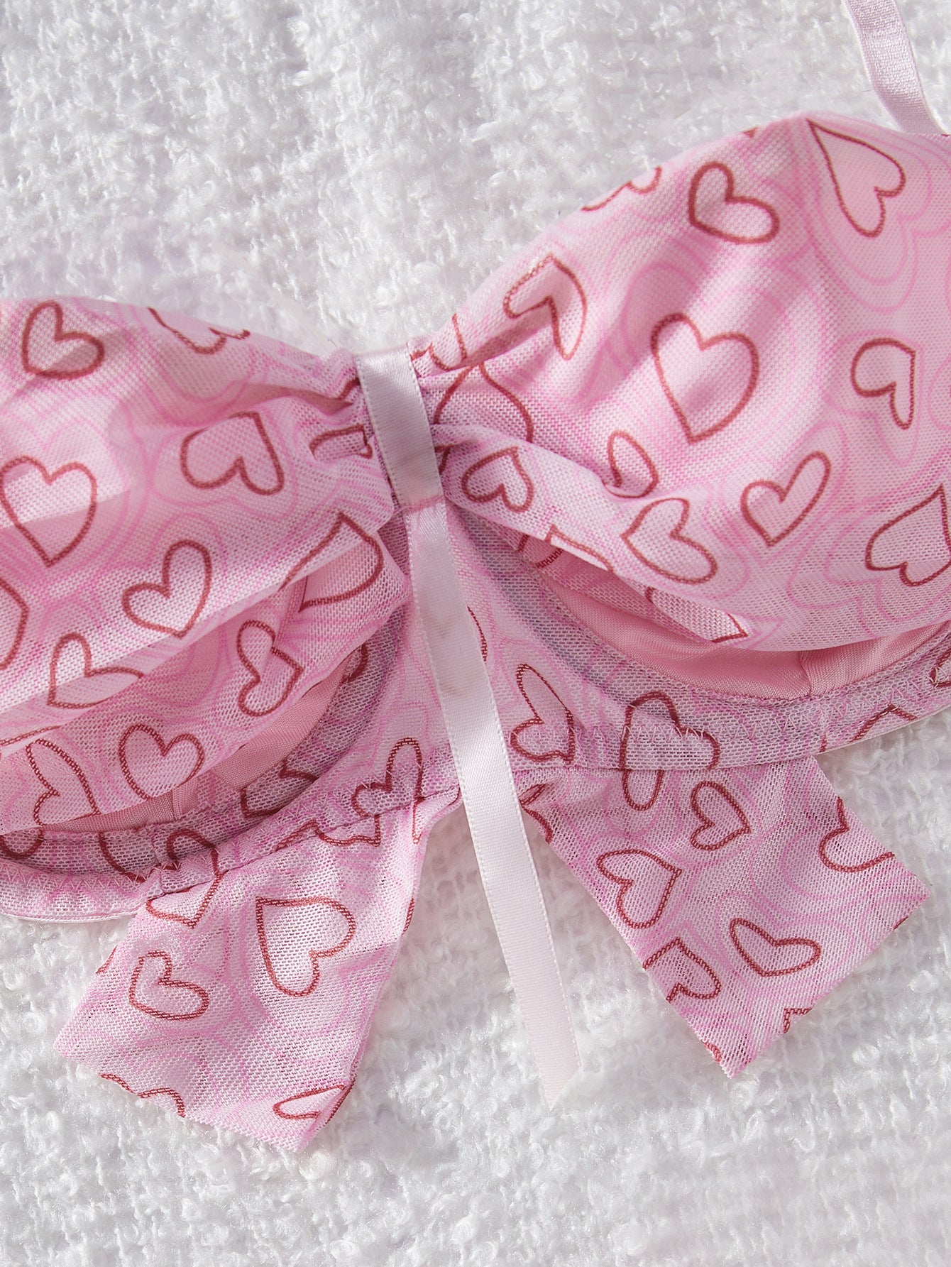 Pink fabric with heart patterns on a white background