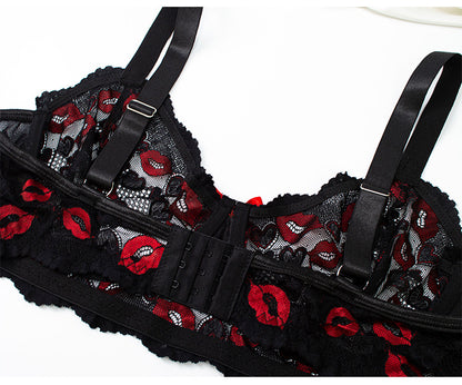 Black lace lingerie with red accents on a white background