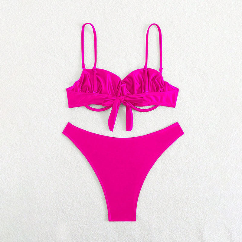 Pink bikini set on a light gray background