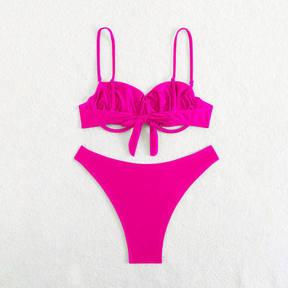 Pink bikini set on a light gray background