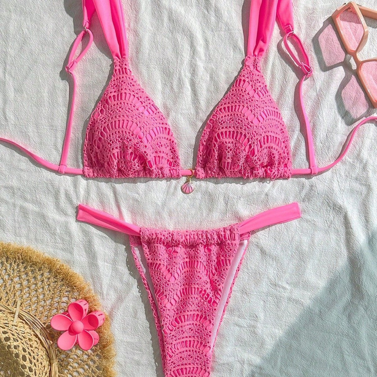 Pink crochet bikini set on a light fabric background