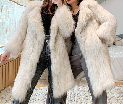 Two women wearing a white fur coat indoors.