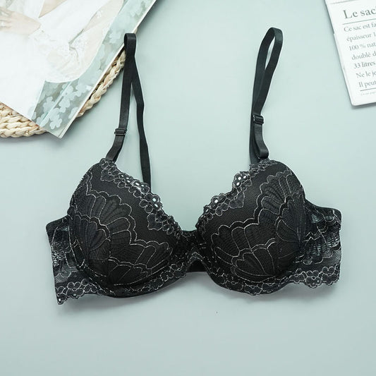 Black lace bra on a light gray background