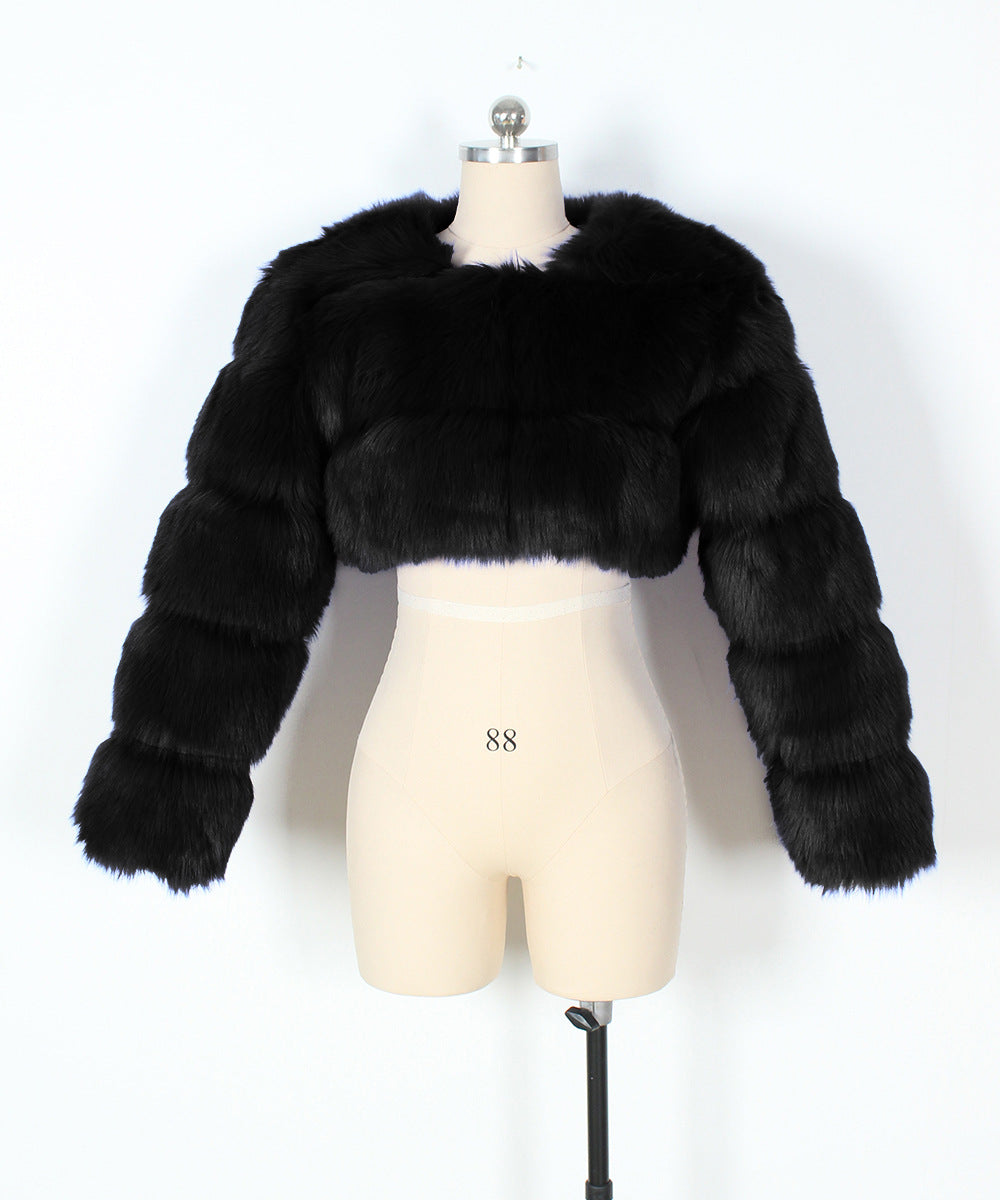 Black fur jacket on a mannequin against a white background