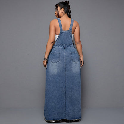 Woman wearing a long denim dress against a gray background