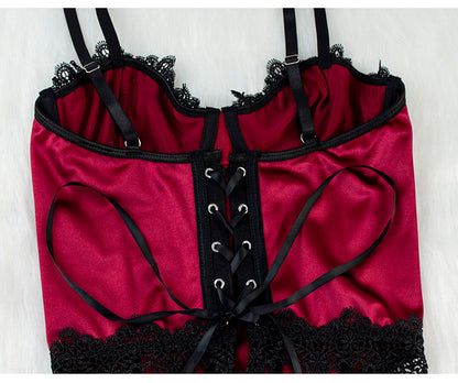 Red lingerie with black lace trim and straps on a white background