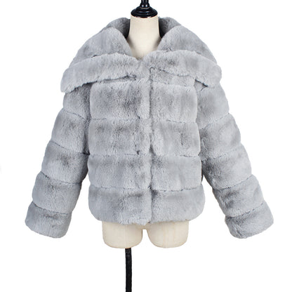 Gray fur coat on a mannequin against a white background