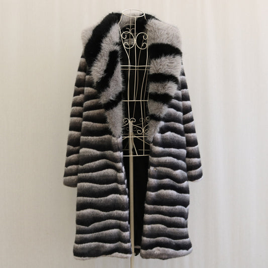 Black and gray striped fur coat on a mannequin against a white background