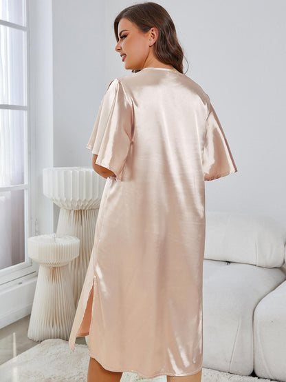 Woman wearing a beige satin robe in a modern living room.