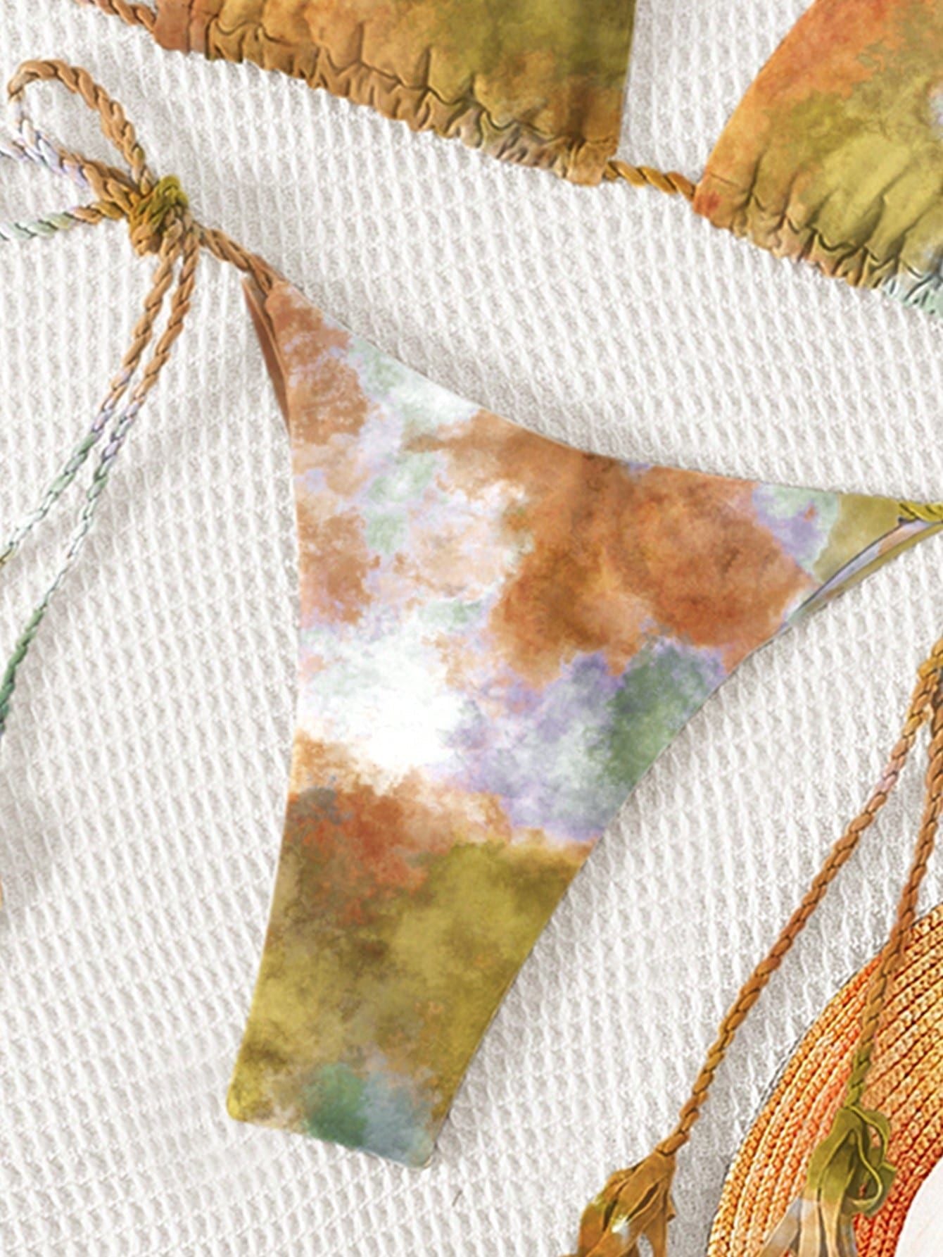 Close-up of a fabric banner with colorful triangular flags on a white background