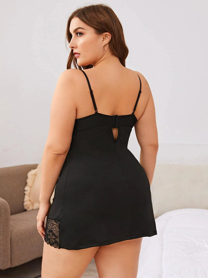 Woman wearing a black lace-trimmed nightgown in a bedroom setting.