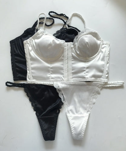 White bra and panties set with black lace details on a white background