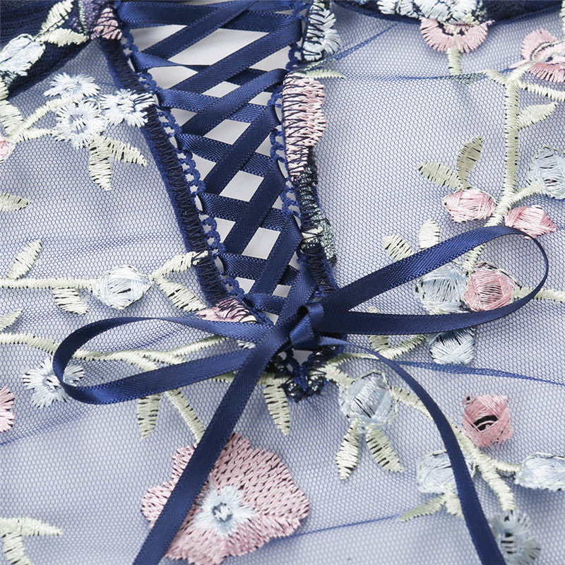 Embroidered fabric with floral patterns and a blue ribbon