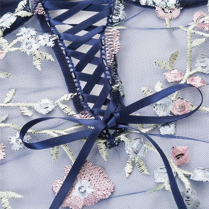 Embroidered fabric with floral patterns and a blue ribbon