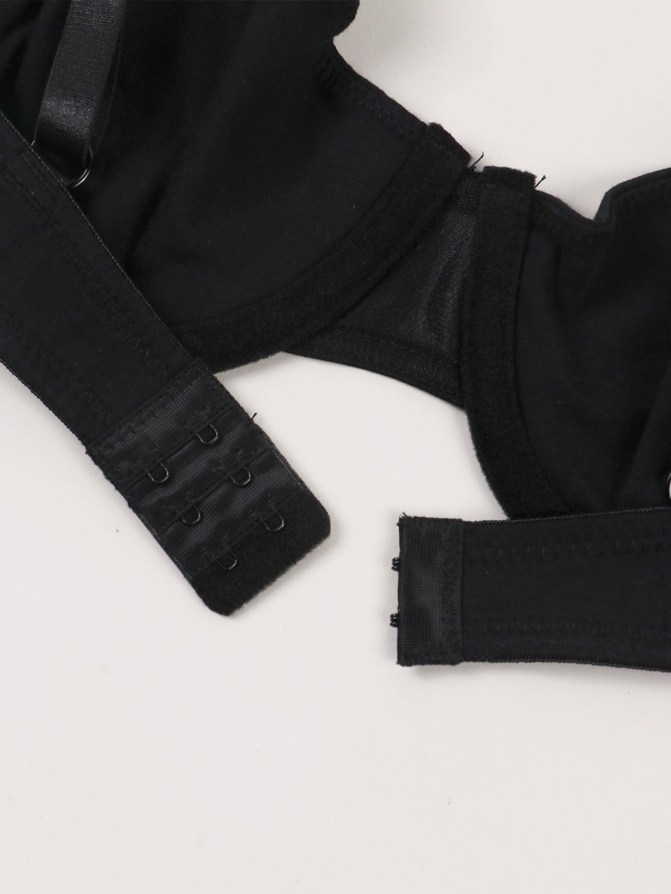 Black bra with straps on a white background