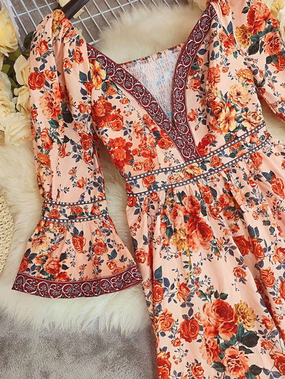 Floral dress with orange and red flowers on a textured surface