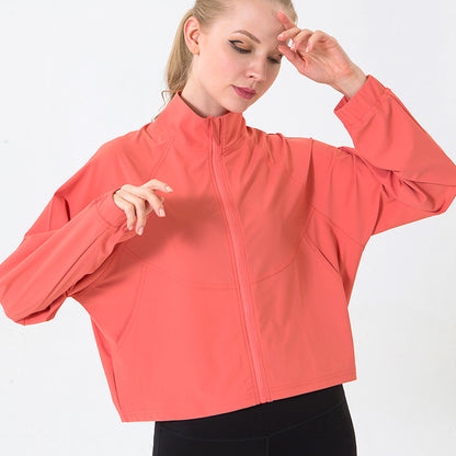 Woman wearing a coral jacket on a white background