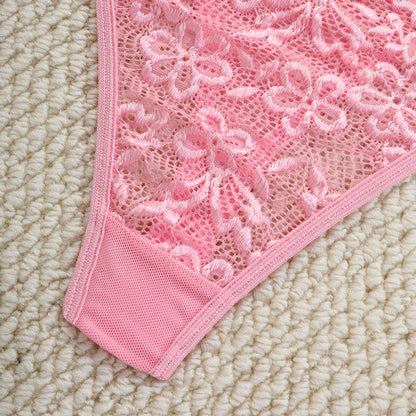 Close-up of a pink lace doily on a beige surface