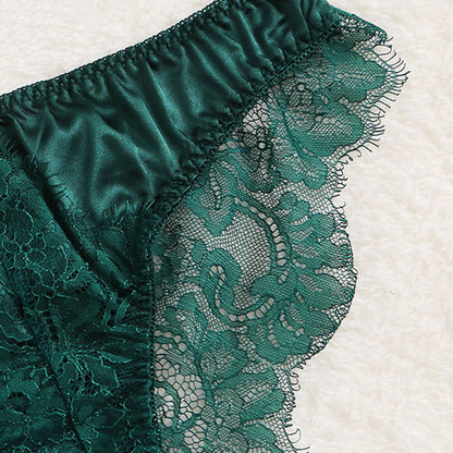 Teal lace fabric on a textured white background