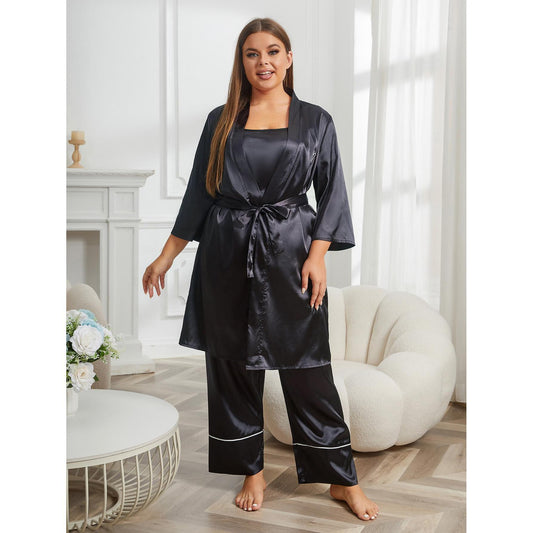 Woman wearing a black satin robe in a stylish room with a fireplace and white furniture.