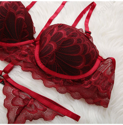 Red lace lingerie set on a white textured surface