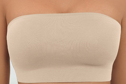 Beige strapless top worn by a person with a blurred background