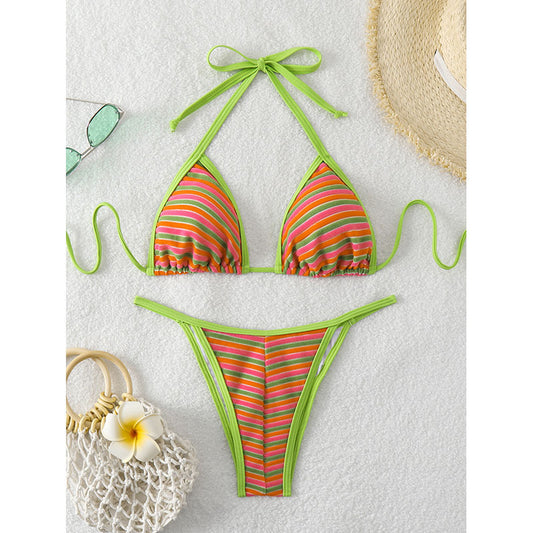 Striped bikini set with green straps on a light gray background