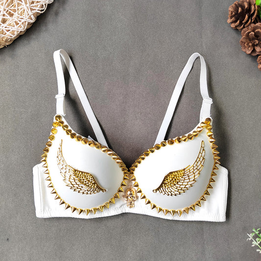 White bra with gold detailing on a gray background