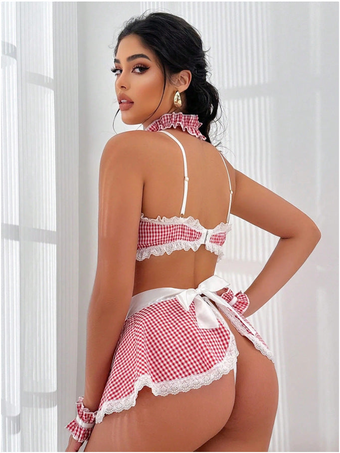 Woman wearing a red and white checkered bikini set with a white lace trim against a light background.
