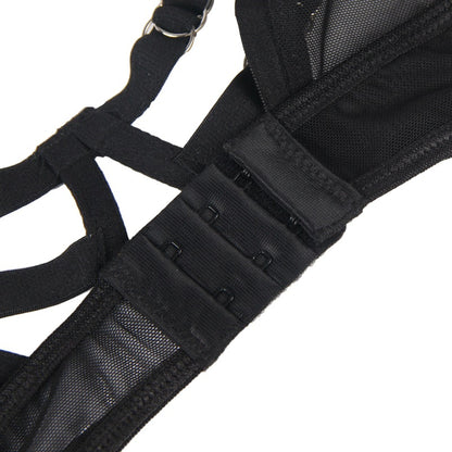 Close-up of a black harness with straps on a white background