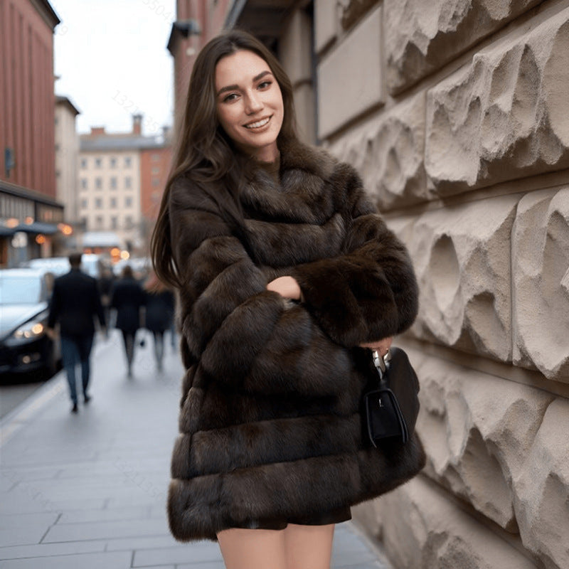 Woman wearing a fur coat standing on a city street.